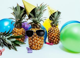 Pineapples whereing sunglasses with balloons for summer party ideas