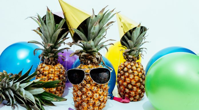 Pineapples whereing sunglasses with balloons for summer party ideas