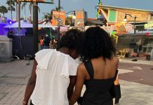 two women facing away from the camera. the younger one is leaning against the older one. Letting go as a parent