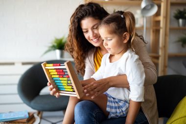 Mother and little girl, kid playing with abacus, early education