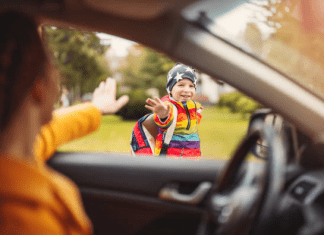 mom waving goodbye to child, a boy, boy smiling and waving back; back to school mom mental health