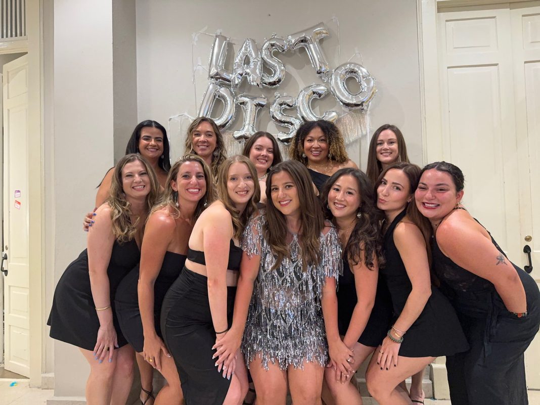 12 women smiling at the camera celebrating Gen Z bachelorette weekend