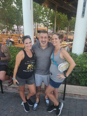 two women a Joey Fatone (singer from N'SYNC) smiling at the camera. 