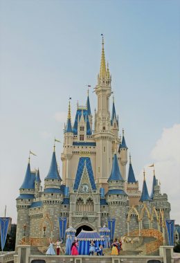 Cinderella Castle with dancing characters on the stage in front of it taken by manish tulaskar via unsplash