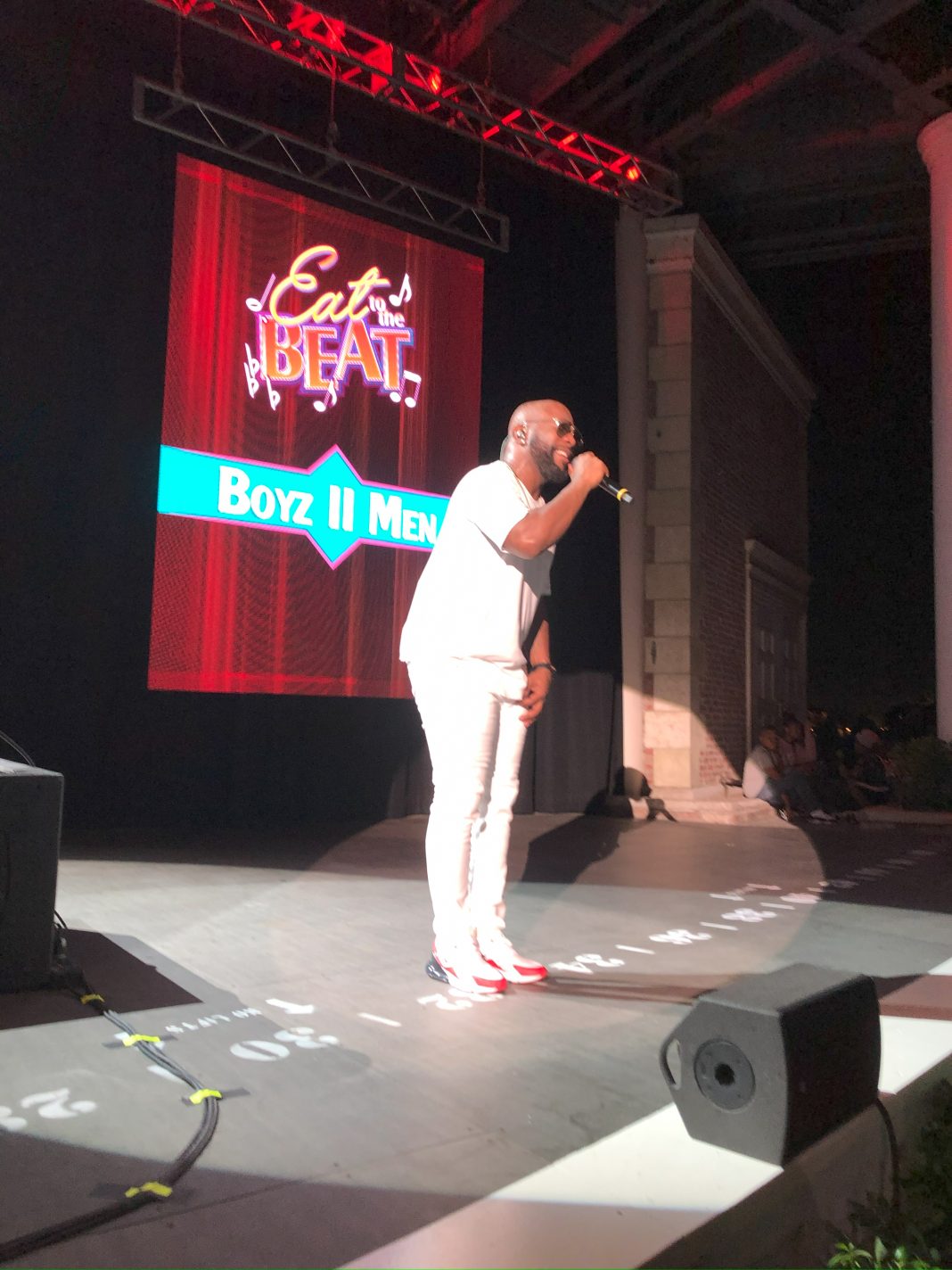 man singing on a stage for eat to the beat concert