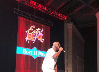 man singing on a stage for eat to the beat concert