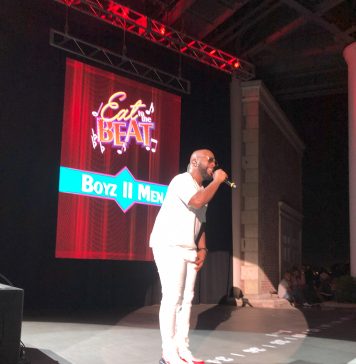 man singing on a stage for eat to the beat concert