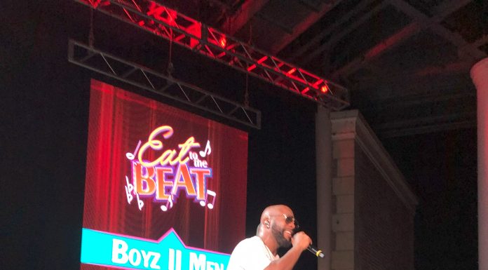 man singing on a stage for eat to the beat concert