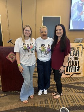 three women smiling at the camera