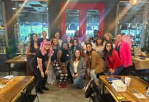 17 women smiling at the camera for prosper and flourish in which some are mom entrepreneurs, child-free woman, or just women in business