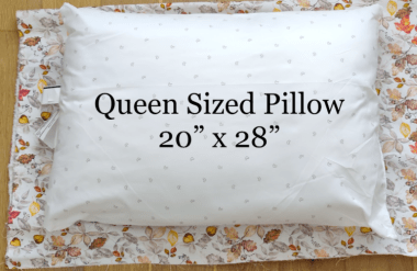 pillow with measurement for reference against fabric. Queen pillow measures 20" x 28"