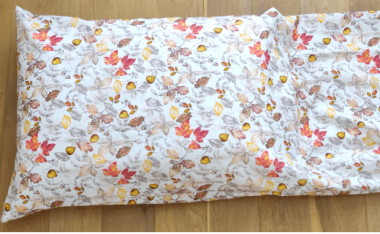 queen pillow inserted in fall fabric with a lot of fabric left over. 