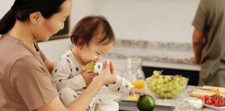 The Health Benefits of Eating Avocados: A Nutrient-Packed Superfood child on kitchen counter eating avocados with mom