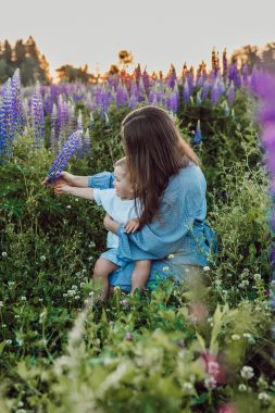 liana-mikah via unsplash woman in a lavender field with a baby on her lap