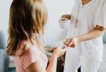 young girl receiving money from probably mom (out of frame) to invest in your child's future