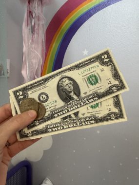 photo of two two-dollar bills and two gold coins for the tooth fairy