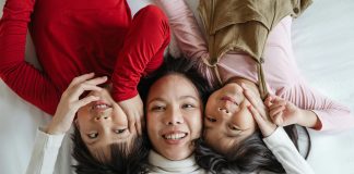 3 Myths of Motherhood to Break This Mother’s Day a mom with her two children; all three smiling up at the camera; myths of motherhood