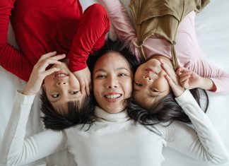 3 Myths of Motherhood to Break This Mother’s Day a mom with her two children; all three smiling up at the camera; myths of motherhood