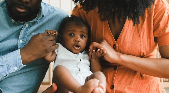 How to Nurture Your Child’s Self-Confidence Parents holding baby up nurture child's self-confidence