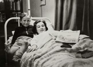 woman, mom, lying in bed with her son next to her. older photo, Balancing Motherhood and Recovery