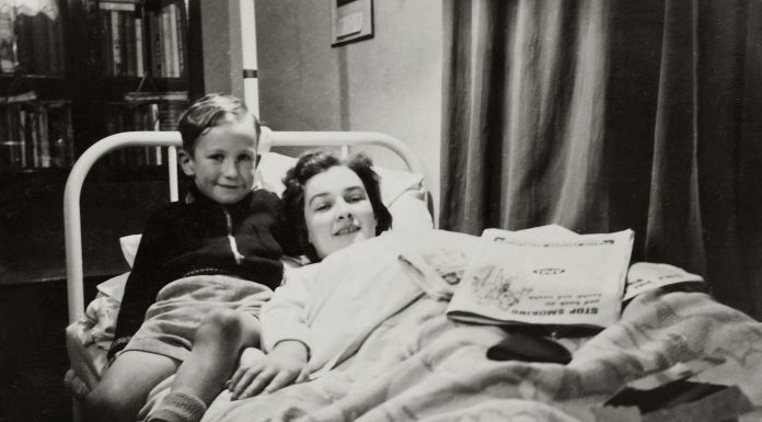 woman, mom, lying in bed with her son next to her. older photo, Balancing Motherhood and Recovery