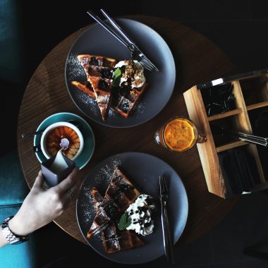a flat lay photos of photo with a hand reaching for the coffee. mother's day brunch at the boheme