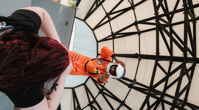 Indoor Activities in Orlando for Rainy or Blazing Hot Days (Attractions Edition) Man dressed in an astronaut suit posing for a photo indoors, showcasing one of the fun and educational indoor activities in Orlando for kids and families.