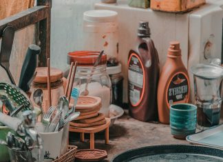 Mental Load of Clutter: Why Summer Mess Feels Heavier — and Four Simple Ways to Reset Kitchen counter crowded with utensils, jars, and sauce bottles illustrating the mental load of clutter during busy summer days