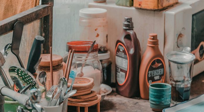 Mental Load of Clutter: Why Summer Mess Feels Heavier — and Four Simple Ways to Reset Kitchen counter crowded with utensils, jars, and sauce bottles illustrating the mental load of clutter during busy summer days