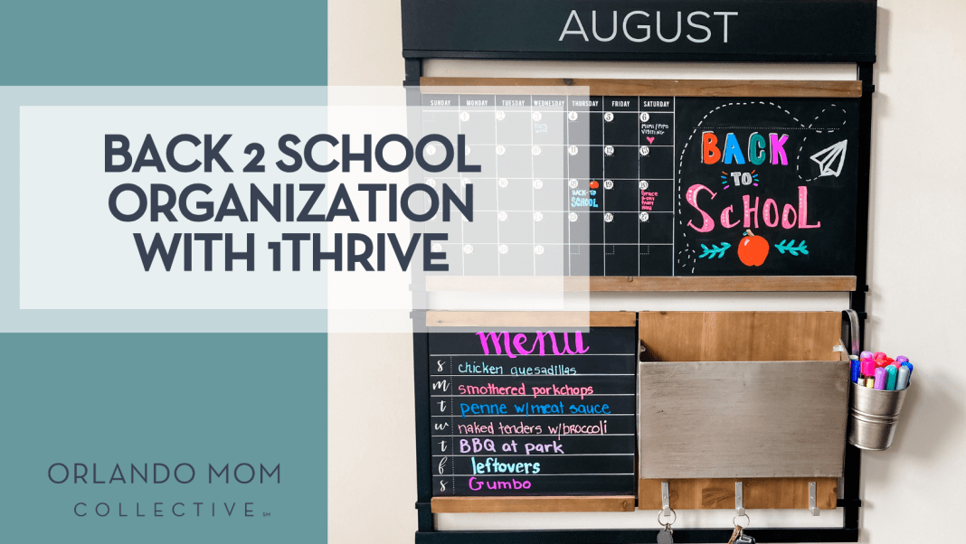 Sweet and Spicy Book Series to Binge Read by the Pool Back-to-School Organization with 1Thrive wall command center showing an August calendar, colorful “Back to School” chalk art, weekly menu board, mail pocket, and cup of markers—all mounted on a sleek black frame for streamlined family scheduling.