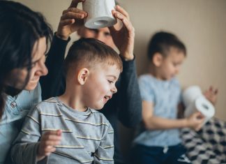 Pelvic Health: Back-to-School Edition Mother and children sitting together at a table, smiling and talking, highlighting family routines and public health awareness.