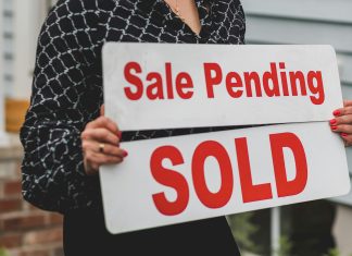 For sale sign in front of a suburban home, symbolizing opportunities in the August housing market