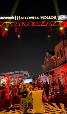 Halloween Horror Bar sign with people walking below it at Universal Studios Florida