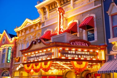 Brian McGowan via Unsplash Main Street Cinema in Magic Kindgom at night with fall banners