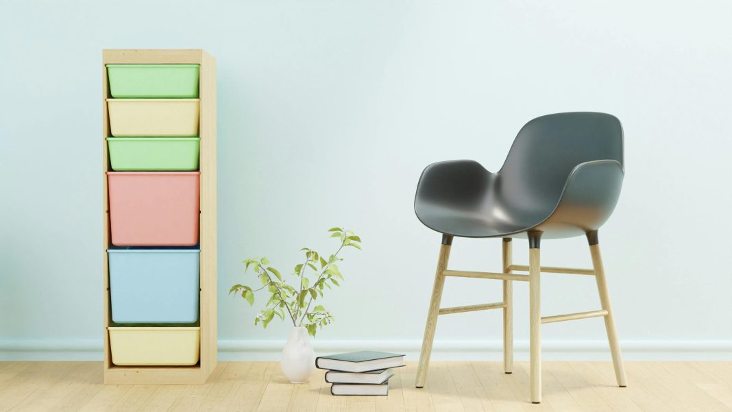 Minimalist home office setup with a black and brown chair beside a white wall, offering distraction-free space ideal for moms with ADHD.
