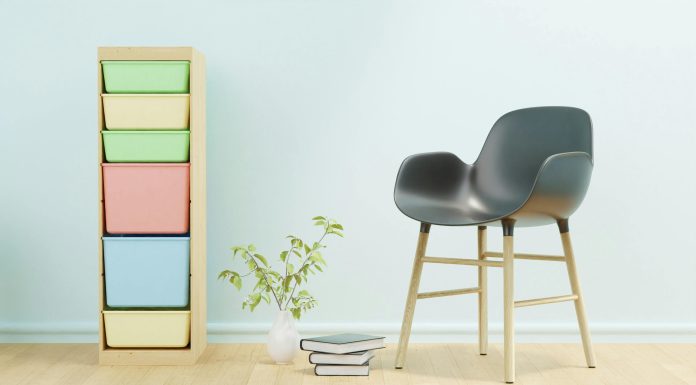 Minimalist home office setup with a black and brown chair beside a white wall, offering distraction-free space ideal for moms with ADHD.