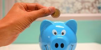 Budget-Friendly Orlando Childcare Options: Tips for Local Families hand putting money in a piggy bank or orlando childcare