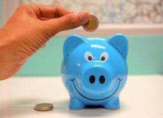 hand putting money in a piggy bank or orlando childcare