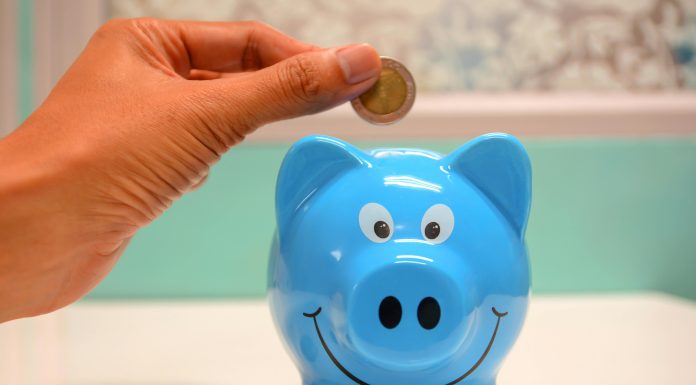 hand putting money in a piggy bank or orlando childcare