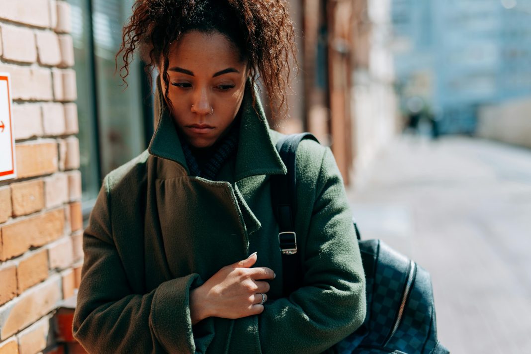 pexels-mikhail-nilov-7929616 woman wrapped up in a coat looking sad, seasonal depression