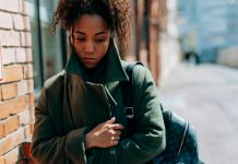 woman wrapped up in a coat looking sad, seasonal depression