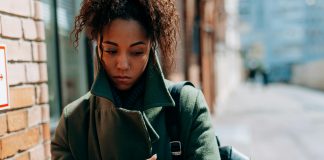 How to Manage Seasonal Depression as a Florida Mom woman wrapped up in a coat looking sad, seasonal depression