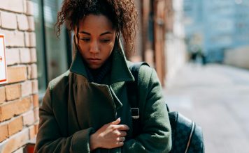 woman wrapped up in a coat looking sad, seasonal depression