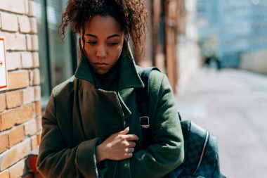 pexels-mikhail-nilov-7929616 woman wrapped up in a coat looking sad, seasonal depression