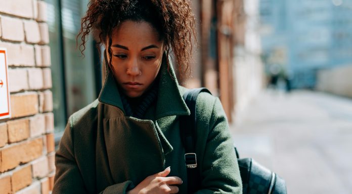 How to Manage Seasonal Depression as a Florida Mom woman wrapped up in a coat looking sad, seasonal depression