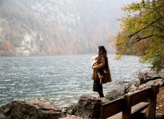 Why Heading Into Fall is the Perfect Time to Reset Your Mental Health Mother holding her baby in a cozy home setting, symbolizing the need to reset your mental health through rest and connection.